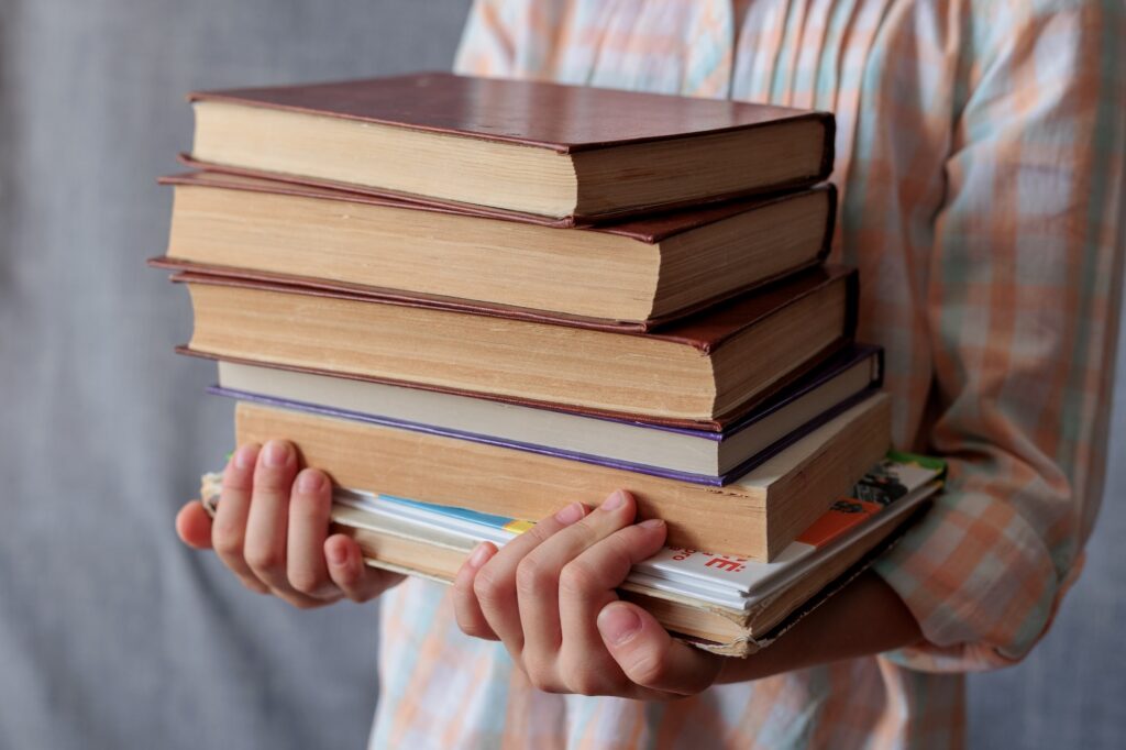 Portrait of a child with books. Reading books.